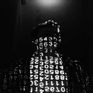 Ein Bild von einem Programmierer, der vor einer Leinwand steht. Das Bild der Leinwand zeigt Bytecode an
